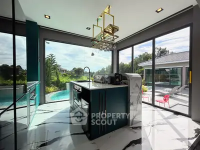 Luxurious modern kitchen with panoramic windows and pool view, featuring sleek design and high-end appliances.