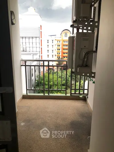 Charming balcony with city view, perfect for relaxation and enjoying the urban landscape.