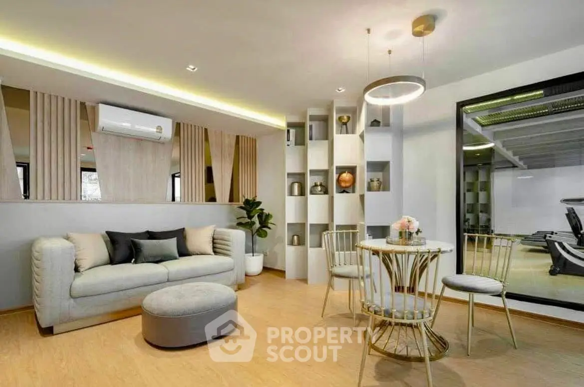 Modern living room with elegant decor and gym view