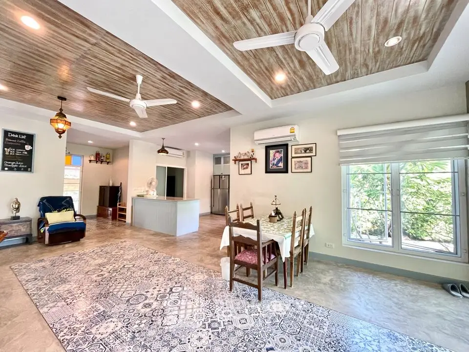 Spacious open-layout living and dining area with modern decor and natural light.