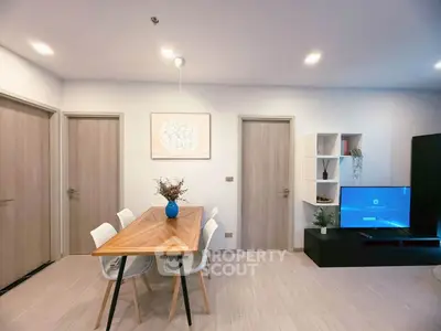 Modern living room with stylish dining area and TV setup, perfect for contemporary living.