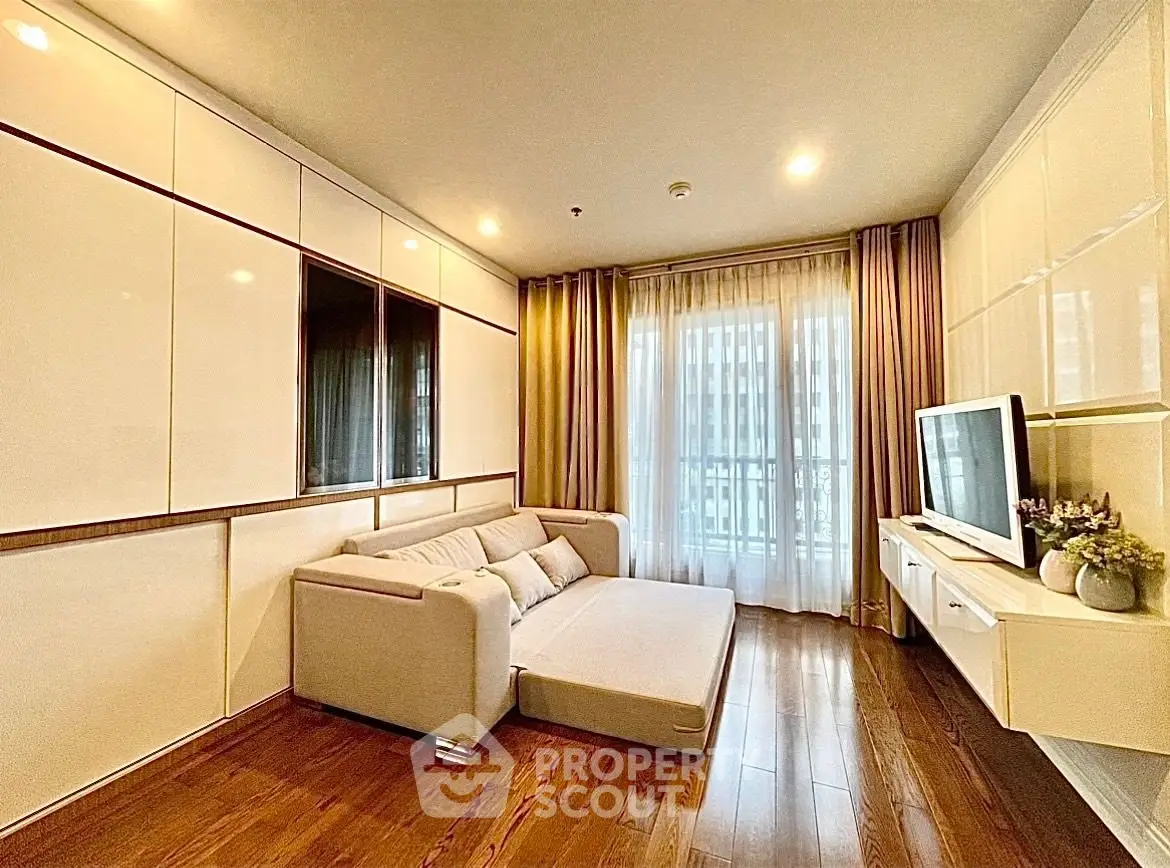 Modern living room with sleek design, featuring a cozy sofa and large window for natural light.