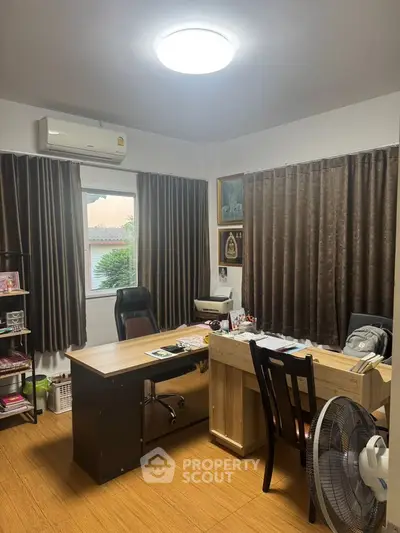 Cozy study room with wooden desk and brown curtains, perfect for focused work.