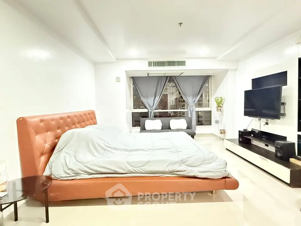 Spacious modern bedroom with large windows and stylish decor