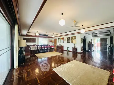 Spacious living room with elegant wooden flooring and ample natural light.