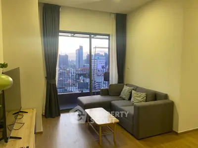 Modern living room with city view and cozy gray sofa