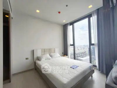 Modern bedroom with large windows offering stunning city views