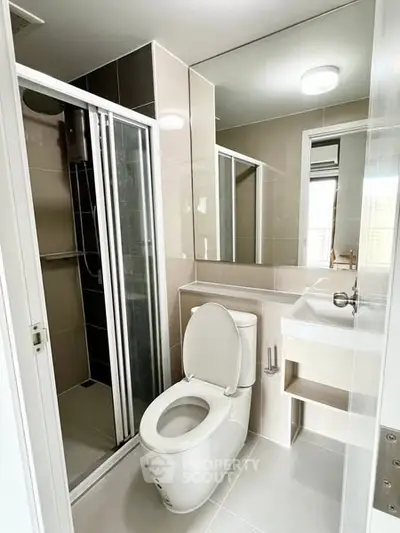 Modern bathroom with sleek shower and elegant fixtures in a contemporary home.