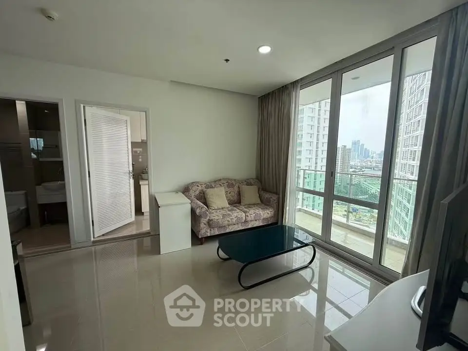 Modern living room with city view and balcony access in high-rise apartment