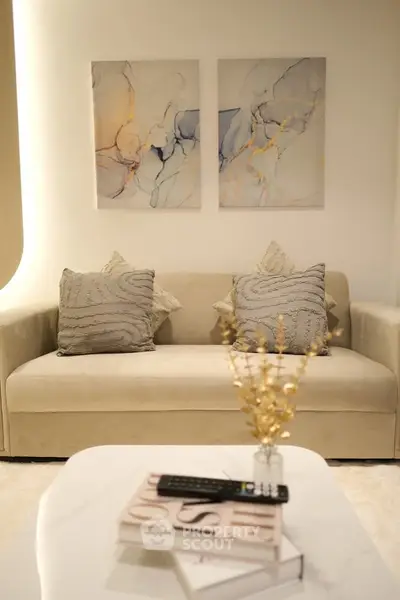 Elegant living room with modern sofa and abstract art, perfect for stylish urban living.