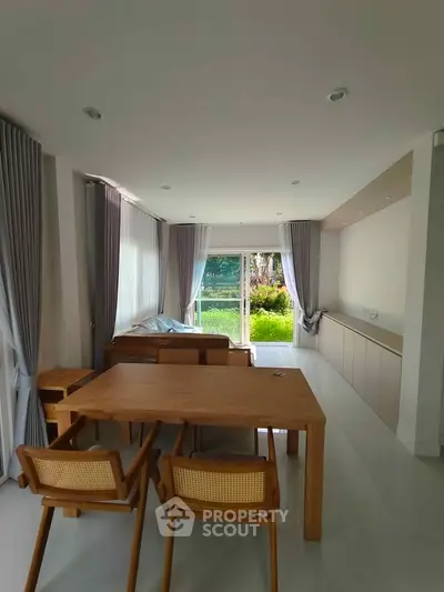 Spacious living room with modern furniture and garden view
