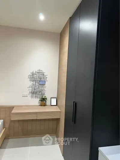 Modern bedroom with sleek black wardrobe and minimalist decor