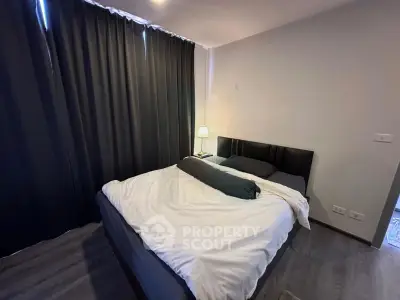 Cozy bedroom with modern decor and soft lighting, featuring a comfortable bed and elegant curtains.