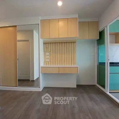 Modern apartment interior with wooden cabinets and sliding glass doors