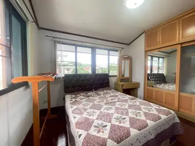 Cozy bedroom with large windows and built-in wardrobe, perfect for natural light lovers.