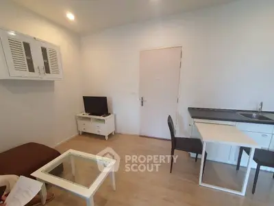 Cozy living room with modern furniture and compact kitchen area