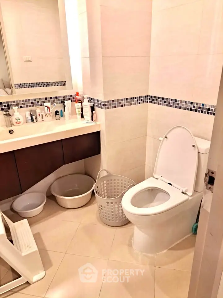 Modern bathroom with sleek fixtures and ample storage space.