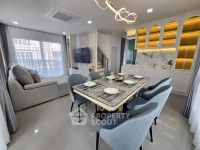 Modern open-plan living and dining area with elegant decor and ample natural light.
