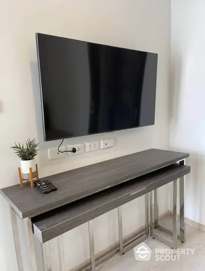 Modern living room with sleek TV setup and stylish console table