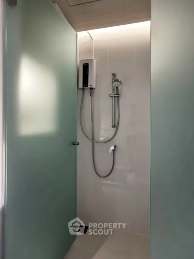 Modern minimalist bathroom with sleek shower design and frosted glass door.