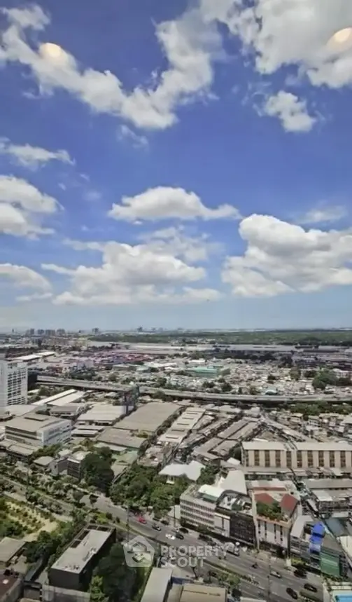 Stunning cityscape view from high-rise building with clear blue skies and urban landscape.