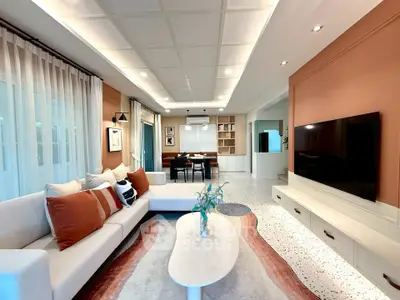 Spacious modern living room with stylish decor and large TV