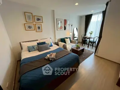 Stylish bedroom with modern decor and cozy seating area, perfect for relaxation.