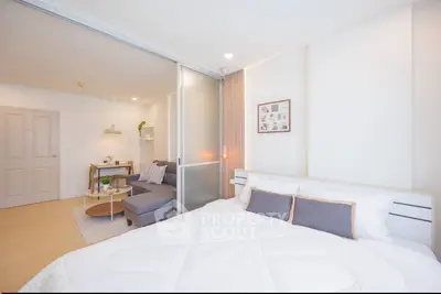 Modern studio apartment with cozy bedroom and stylish living area, perfect for urban living.