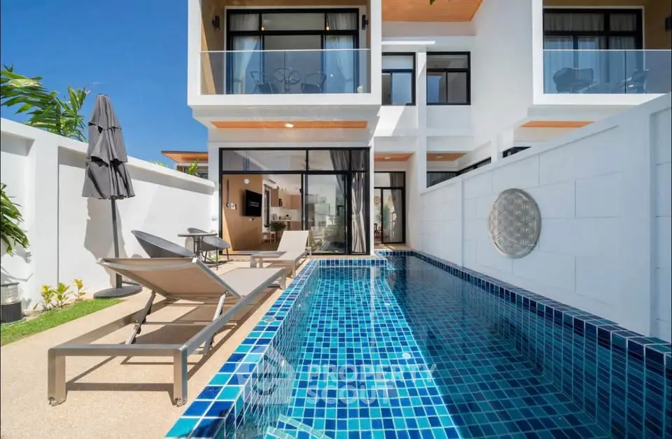 Luxurious modern villa with private pool and sun loungers, perfect for relaxation and entertainment.