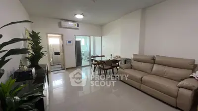 Modern living room with sleek furniture and glass partition