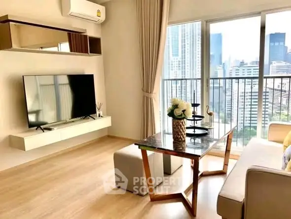Modern living room with city view, featuring sleek furniture and large windows for natural light.