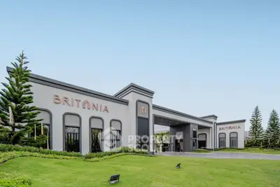 Elegant entrance of Britania residential complex with lush landscaping and modern architecture.