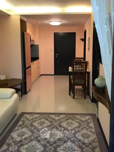 Charming open-plan living and dining area with modern kitchen in cozy apartment.