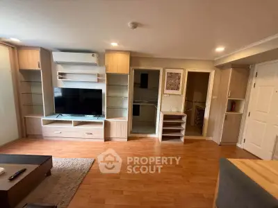 Spacious living room with modern wooden flooring and built-in entertainment unit