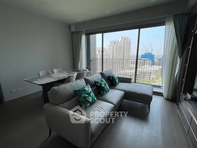 Spacious living room with modern sofa and city view balcony in luxury apartment