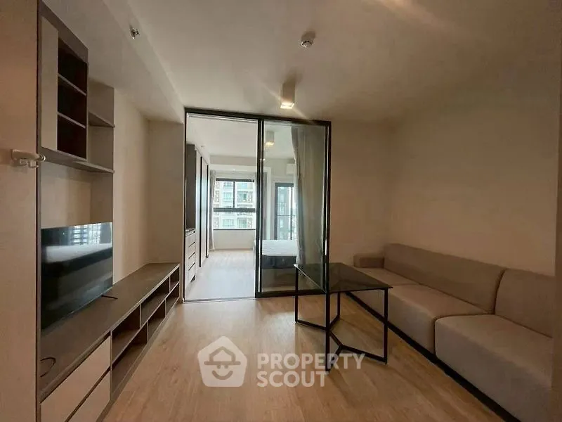 Modern living room with glass partition and sleek furniture