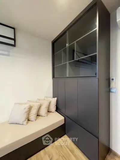 Modern living room with sleek built-in storage and cozy seating area.