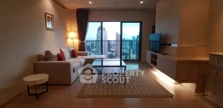 Spacious living room with city view, modern furniture, and large windows in a high-rise apartment.