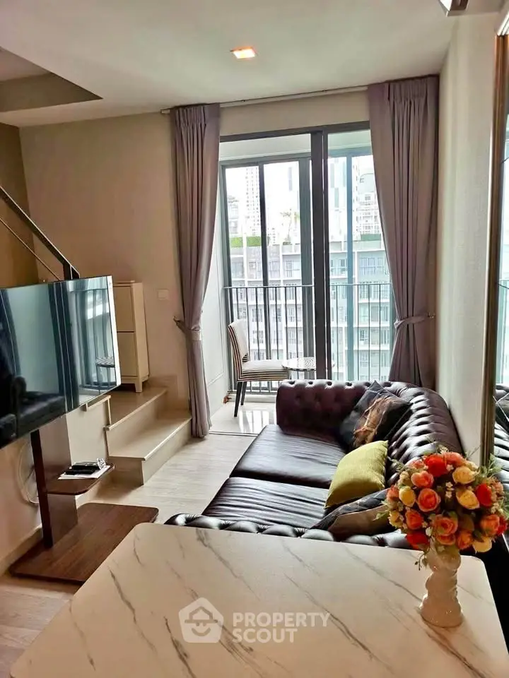 Stylish living room with modern decor and city view, featuring a cozy sofa and elegant curtains.