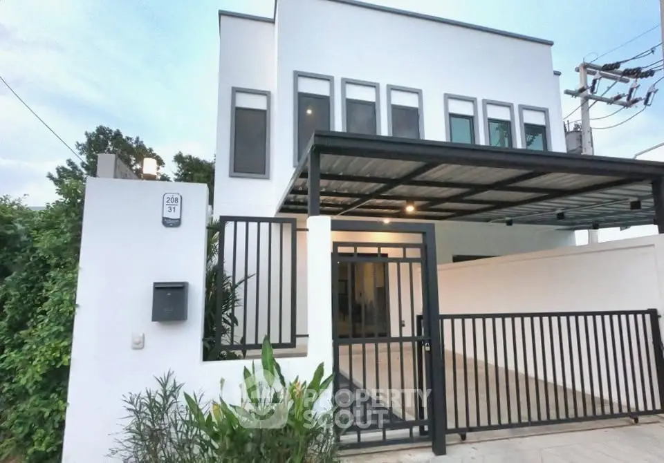 Modern two-story house with sleek design and gated entrance