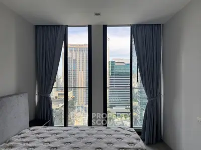 Modern bedroom with stunning city view through floor-to-ceiling windows