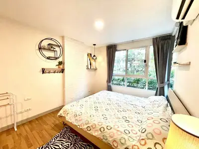 Bright and cozy bedroom with large window and modern decor