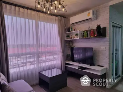 Cozy and modern living room with stylish furnishings, ambient lighting, and access to a sunlit balcony, perfect for urban living.