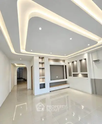 Modern living room with sleek ceiling lights and glossy tiled floor