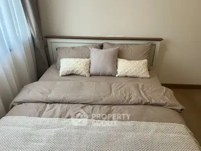 Cozy bedroom with stylish bedding and soft lighting, perfect for relaxation.