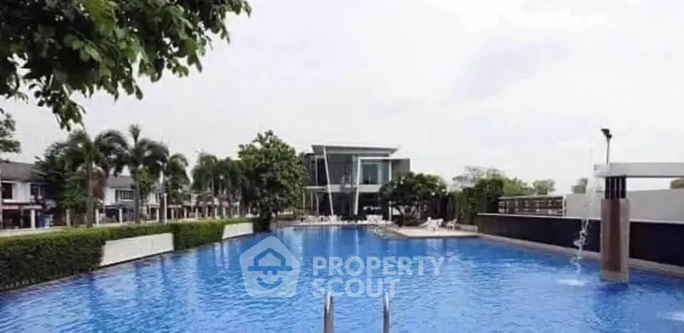Luxurious residential complex with a stunning outdoor pool and modern architecture.