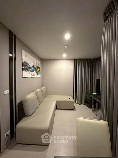 Modern living room with sleek design and cozy seating area, perfect for relaxation.