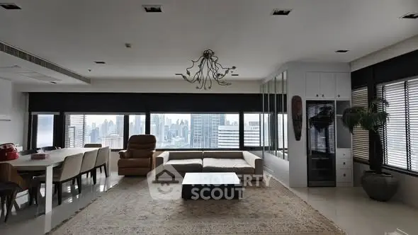 Spacious modern living room with panoramic city view and elegant decor.