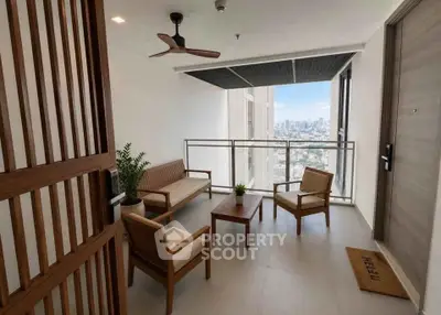 Stylish balcony with city view, modern seating, and ceiling fan for ultimate relaxation.