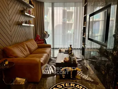 Luxurious living room with leather sofa, modern decor, and large TV, perfect for stylish urban living.